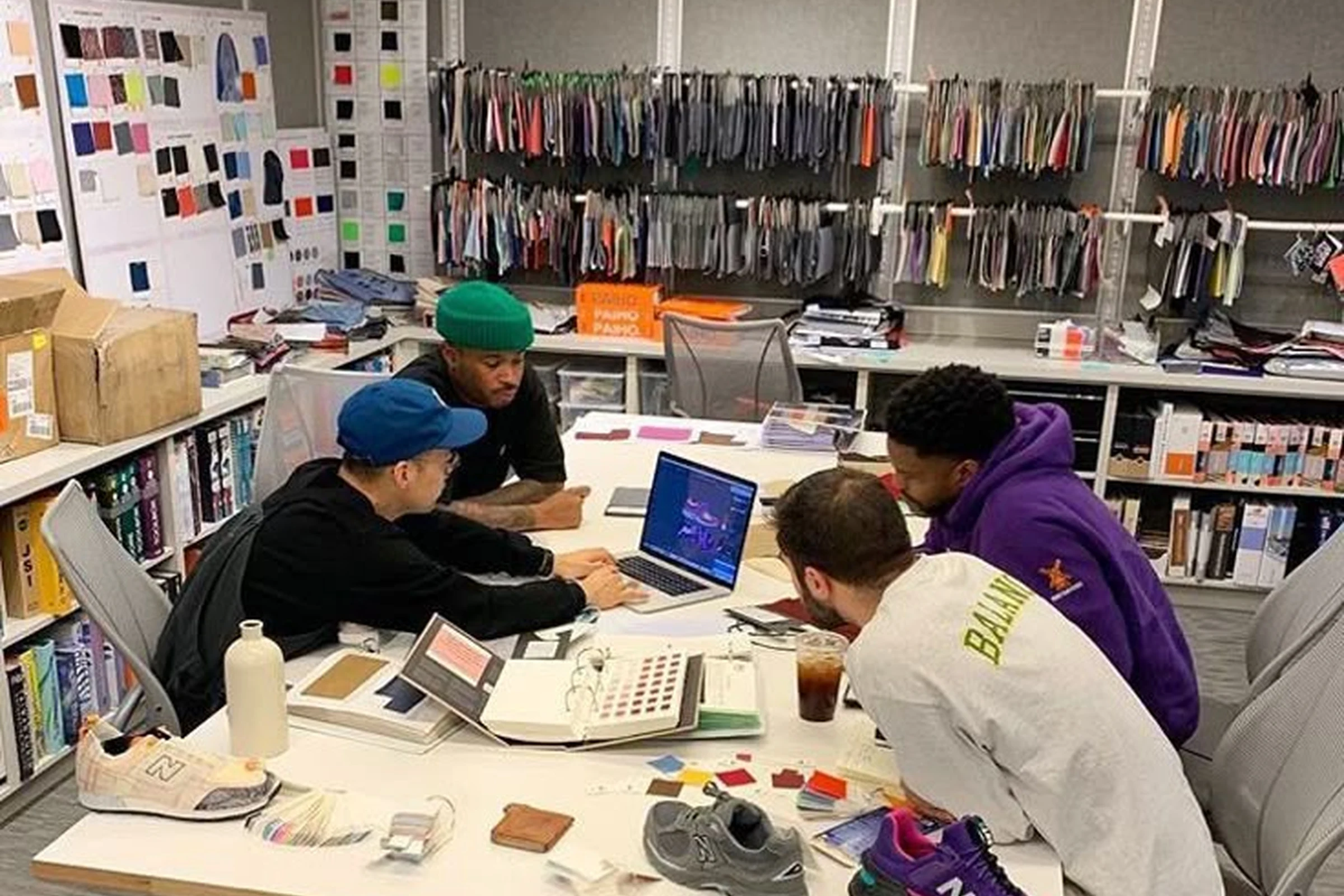 A clothing brand founder reviewing samples with a production specialist
