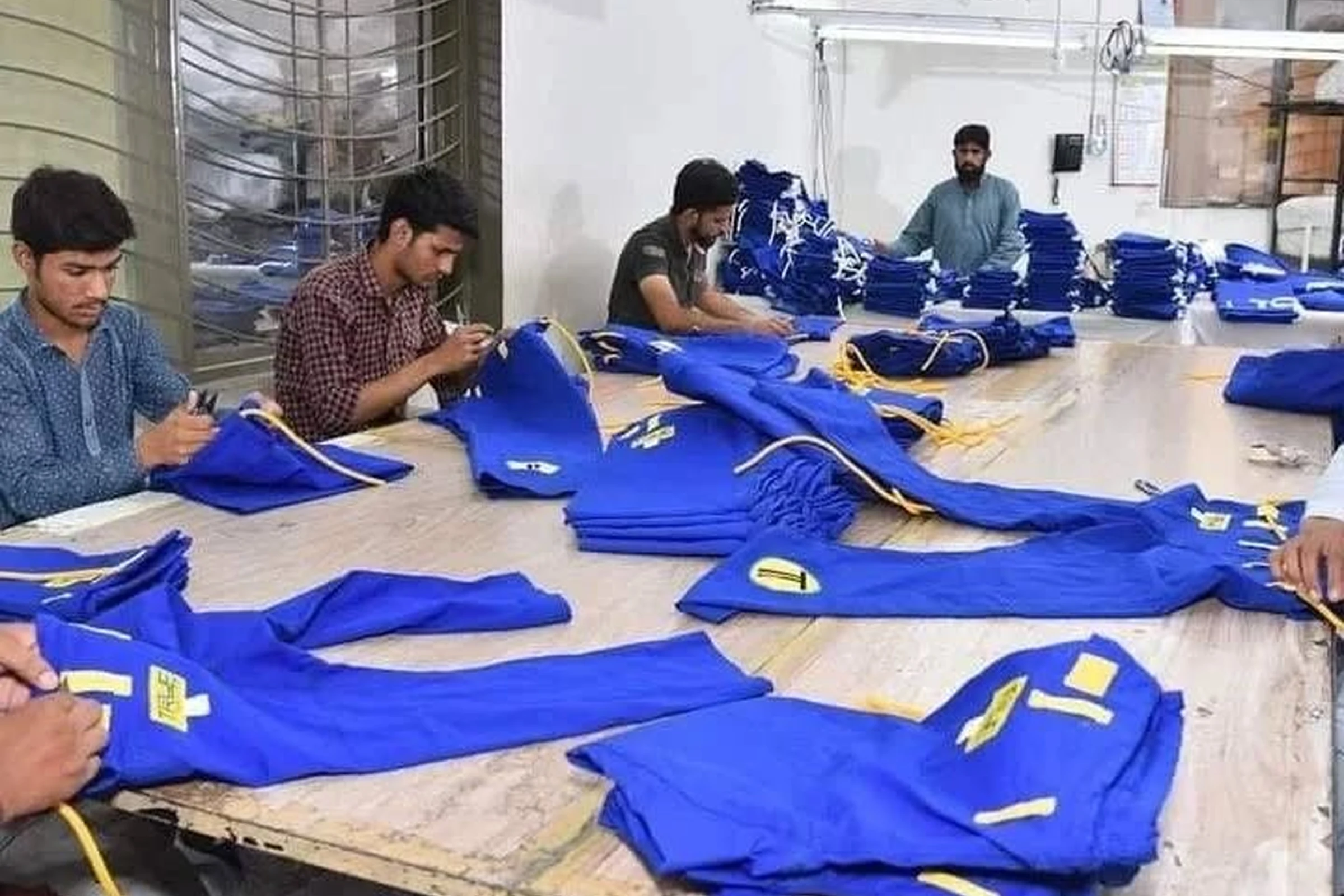 A quality specialist inspecting a finished garment